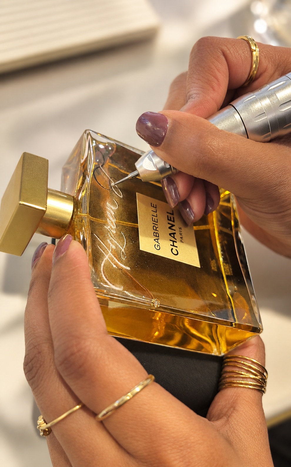 Live hand-engraving of a Chanel perfume bottle at a Dublin brand activation event